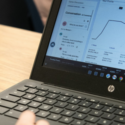 a student at a laptop looking at the stock market